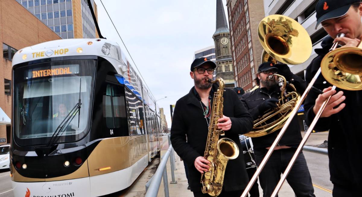 Musicians performing in front of a streetcar
